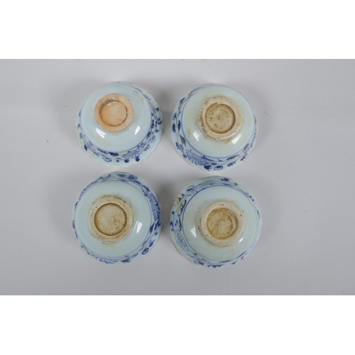 116 - Four Chinese Ming style blue and white porcelain tea bowls decorated with flowers, carp, figures and... 