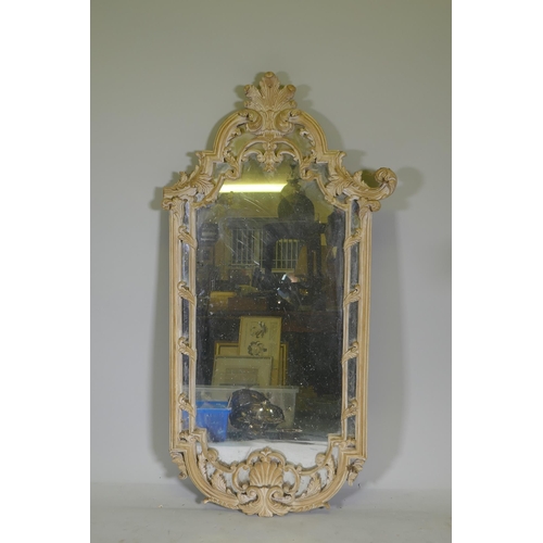 1166 - A carved and painted wall mirror, AF losses, 136cm high