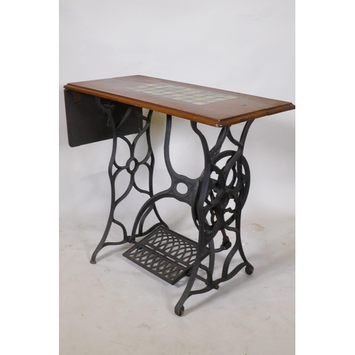 1173 - A Victorian cast iron sewing machine table, with later tiled top, 86 x 41 x 74cm