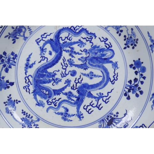 119 - A Chinese blue and white porcelain charger with lobed rim, decorated with two dragons chasing a flam... 