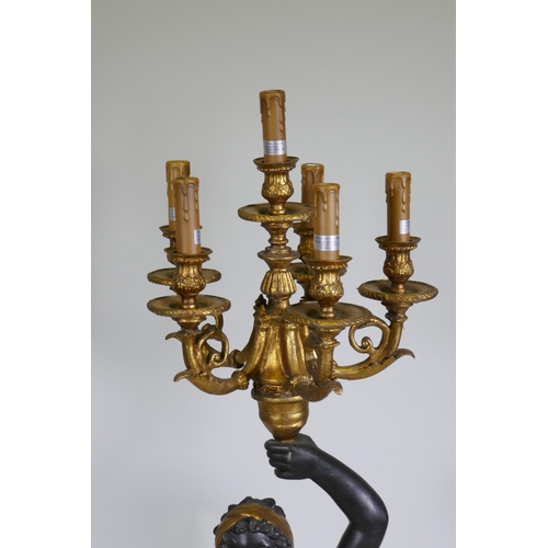 121 - A pair of composition blackamoor five branch torcheres, 126cm high