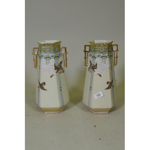 123 - A pair of porcelain vases with gilt highlights and raised decoration depicting flying geese, 31cm hi... 