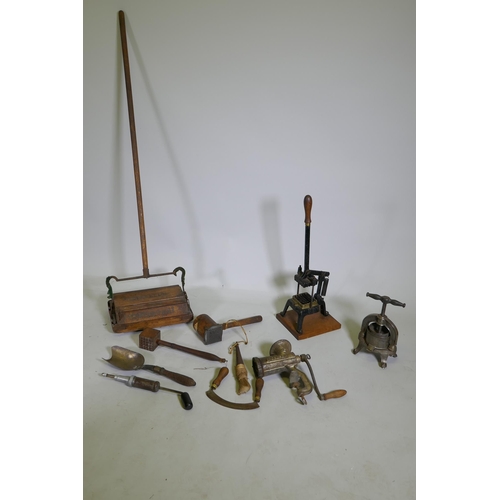 129 - A quantity of vintage kitchenalia, to include a cast metal French fruit/cheese press, a cast iron ma... 