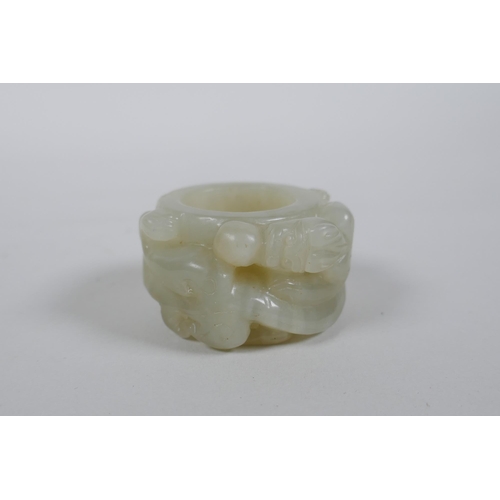 135 - A Chinese grey jade archer's thumb ring with carved dragon decoration, 4.5cm diameter