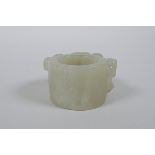 135 - A Chinese grey jade archer's thumb ring with carved dragon decoration, 4.5cm diameter