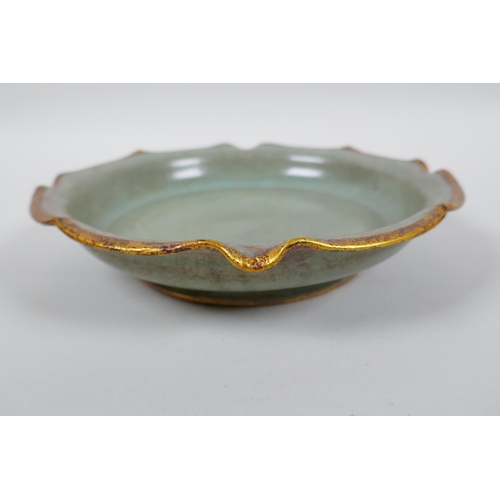 137 - A Chinese celadon glazed porcelain dish with gilt metal lobed rim, chased and gilt character inscrip... 