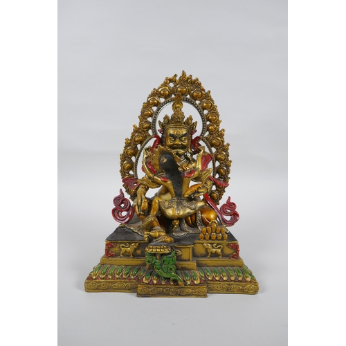 139 - A Tibetan painted and gilt bronze figure of the deity Jambhala, 24cm high