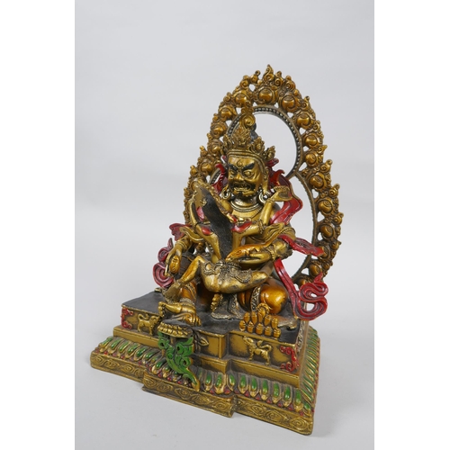 139 - A Tibetan painted and gilt bronze figure of the deity Jambhala, 24cm high