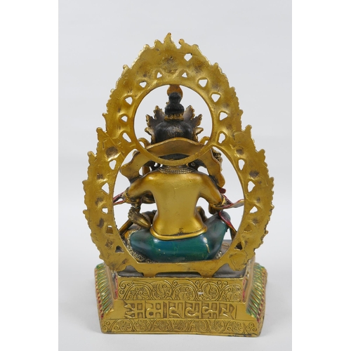 139 - A Tibetan painted and gilt bronze figure of the deity Jambhala, 24cm high