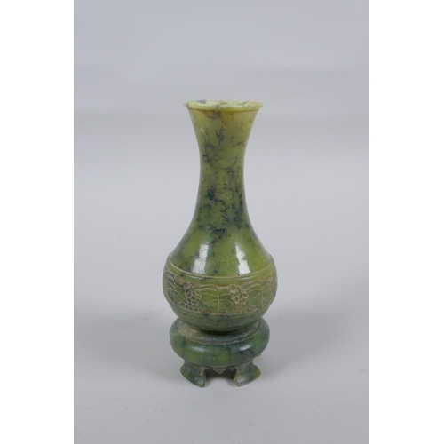 140 - A Chinese mottled green jade stem vase, 13cm high