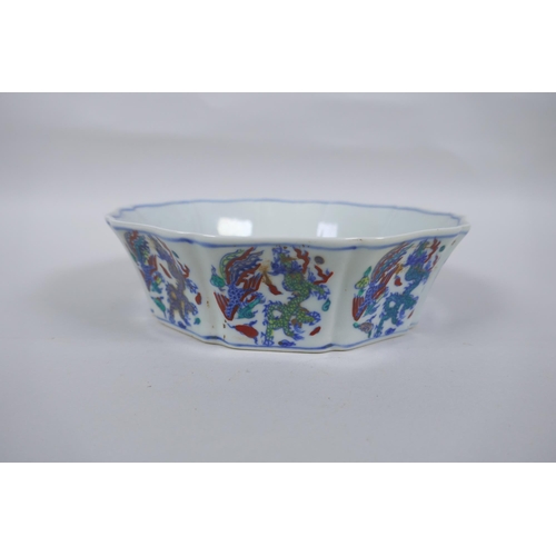 144 - A Chinese Wucai porcelain steep sided bowl of lobed form, with allover dragon and phoenix decoration... 