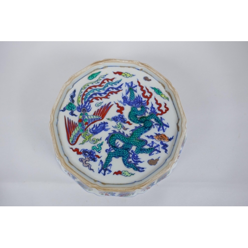 144 - A Chinese Wucai porcelain steep sided bowl of lobed form, with allover dragon and phoenix decoration... 