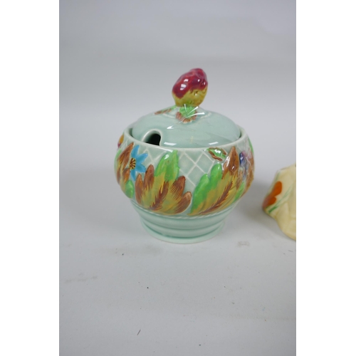 145 - A Clarice Cliff Bizarre Crocus pattern flower frog, a Clarice Cliff for Newport Pottery sugar pot, a... 