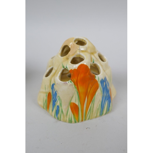 145 - A Clarice Cliff Bizarre Crocus pattern flower frog, a Clarice Cliff for Newport Pottery sugar pot, a... 