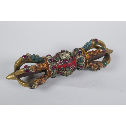 152 - A Tibetan ceremonial bronze vajra with painted details and stone settings, 23cm long