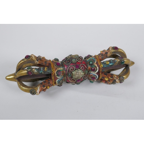 152 - A Tibetan ceremonial bronze vajra with painted details and stone settings, 23cm long