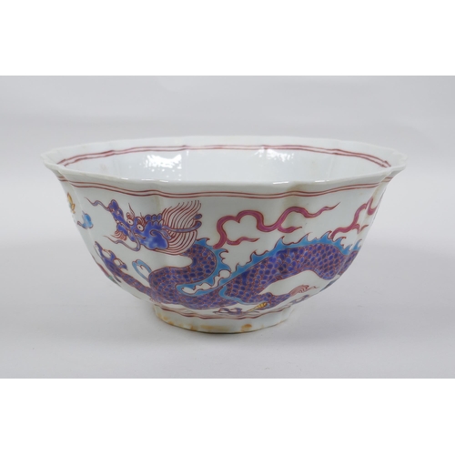 153 - A Chinese polychrome porcelain bowl with lobed rim, decorated with dragons to the exterior and flowe... 