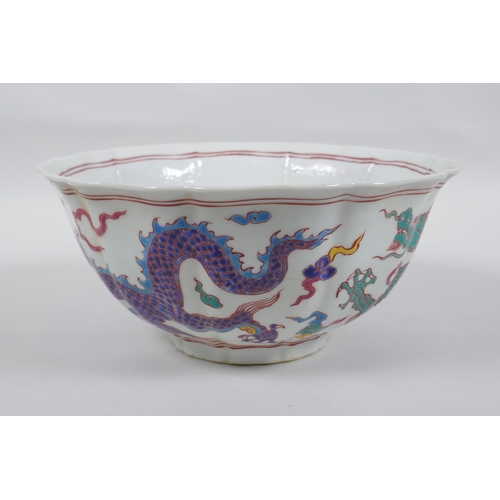 153 - A Chinese polychrome porcelain bowl with lobed rim, decorated with dragons to the exterior and flowe... 