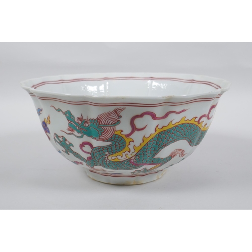 153 - A Chinese polychrome porcelain bowl with lobed rim, decorated with dragons to the exterior and flowe... 