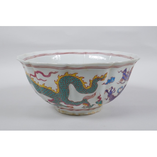 153 - A Chinese polychrome porcelain bowl with lobed rim, decorated with dragons to the exterior and flowe... 