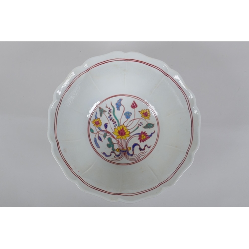 153 - A Chinese polychrome porcelain bowl with lobed rim, decorated with dragons to the exterior and flowe... 