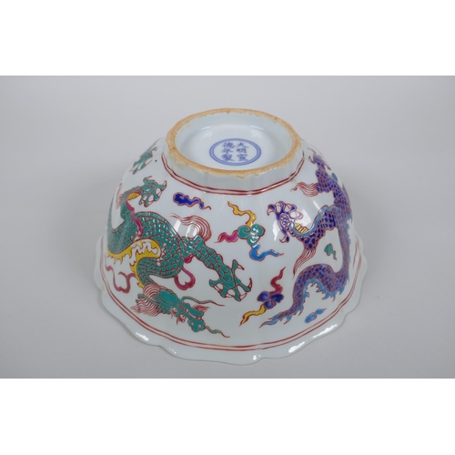 153 - A Chinese polychrome porcelain bowl with lobed rim, decorated with dragons to the exterior and flowe... 