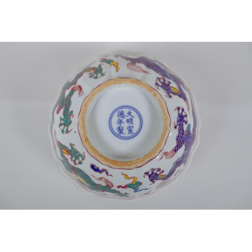 153 - A Chinese polychrome porcelain bowl with lobed rim, decorated with dragons to the exterior and flowe... 