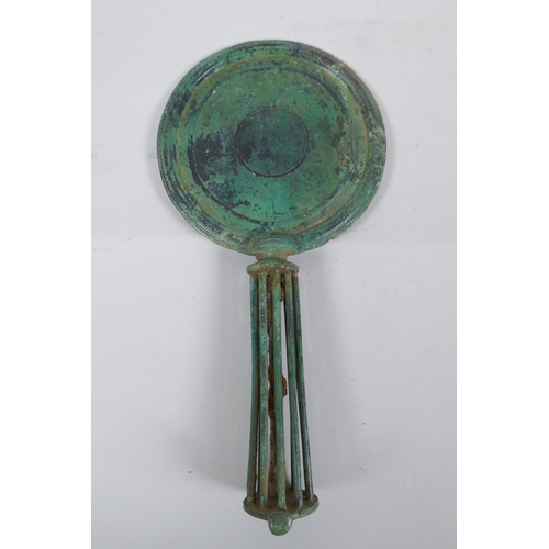 161 - An antique bronze hand mirror, possibly Etruscan, 29cm long