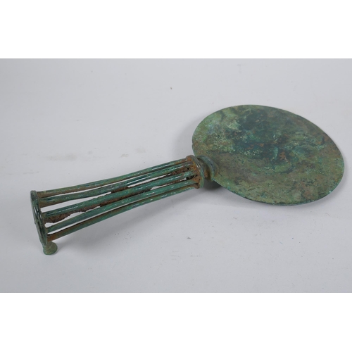 161 - An antique bronze hand mirror, possibly Etruscan, 29cm long