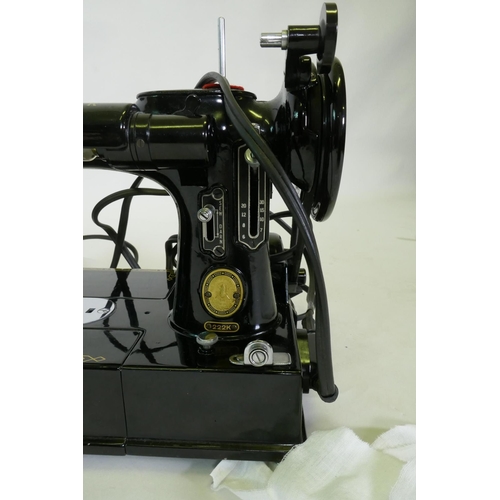 164 - A vintage Singer 222K electric sewing machine, appears unused, and a sewing workbox