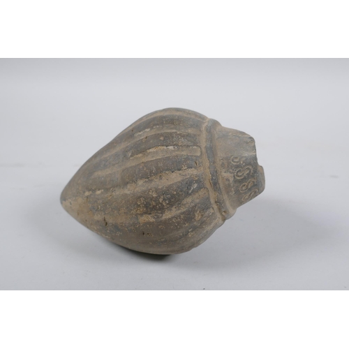 165 - An early ceramic hand grenade/bomb, possibly C12th/C13th, with ribbed body and impressed motifs, 13c... 