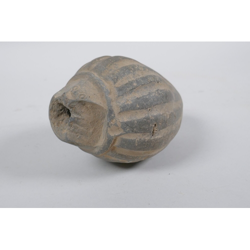 165 - An early ceramic hand grenade/bomb, possibly C12th/C13th, with ribbed body and impressed motifs, 13c... 