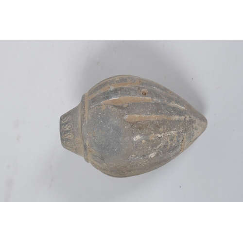 165 - An early ceramic hand grenade/bomb, possibly C12th/C13th, with ribbed body and impressed motifs, 13c... 