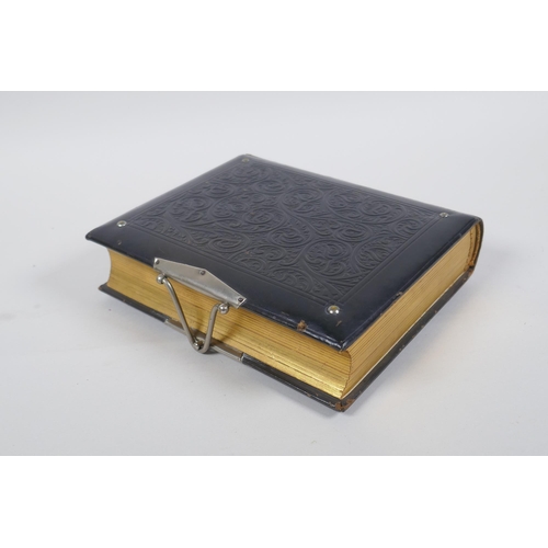 167 - A Victorian tooled leather photograph album with silver plated mounts, 17 x 20cm