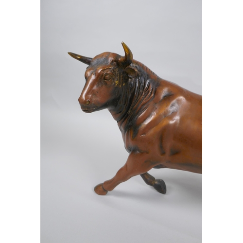 170 - A filled coppered metal bull, 30cm long