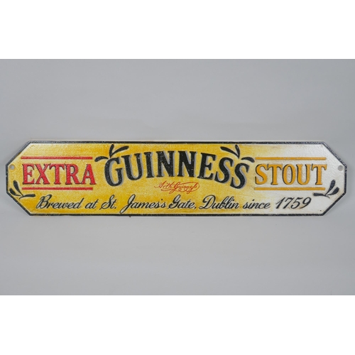 172 - A painted cast iron 'Guinness Extra Stout' advertising sign, 57 x 13cm