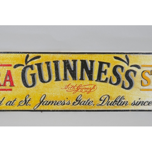 172 - A painted cast iron 'Guinness Extra Stout' advertising sign, 57 x 13cm