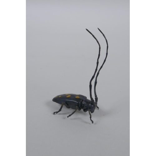 175 - A Japanese style bronze okimono elderberry  longhorn beetle with gilt splash decoration to the ... 