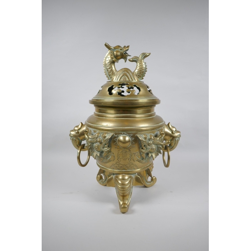 180 - A Chinese bronze censer and cover with tripod elephant head supports, twin dragon head loop handles,... 