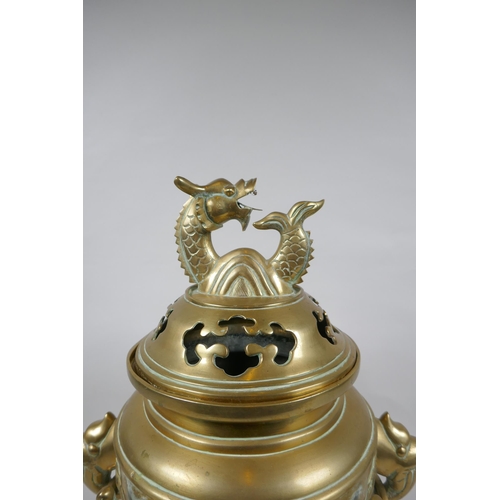 180 - A Chinese bronze censer and cover with tripod elephant head supports, twin dragon head loop handles,... 