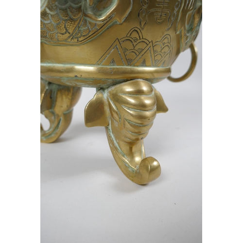 180 - A Chinese bronze censer and cover with tripod elephant head supports, twin dragon head loop handles,... 