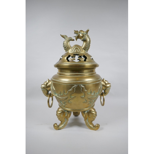 180 - A Chinese bronze censer and cover with tripod elephant head supports, twin dragon head loop handles,... 