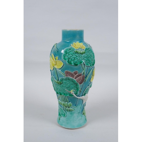 19 - A C19th Chinese Sancai glazed porcelain vase with raised decoration of a wading bird in a lotus flow... 