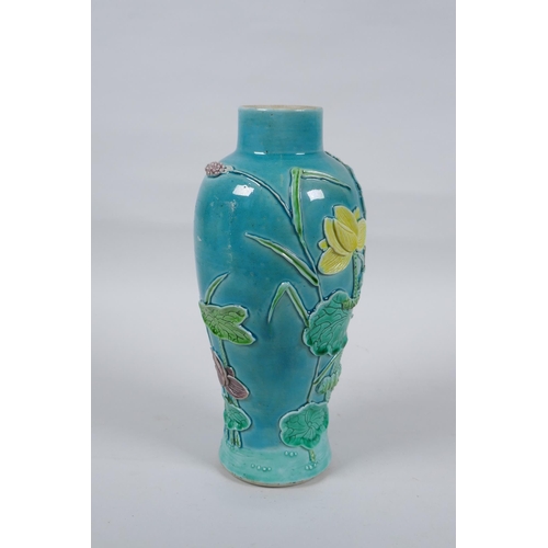 19 - A C19th Chinese Sancai glazed porcelain vase with raised decoration of a wading bird in a lotus flow... 