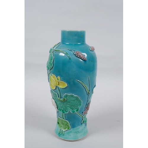 19 - A C19th Chinese Sancai glazed porcelain vase with raised decoration of a wading bird in a lotus flow... 