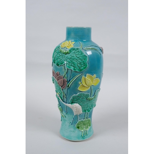 19 - A C19th Chinese Sancai glazed porcelain vase with raised decoration of a wading bird in a lotus flow... 