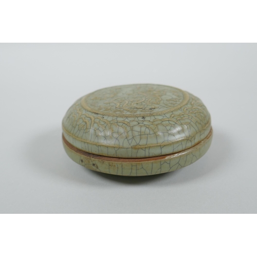 191 - A Chinese celadon crackle glazed porcelain box and cover with raised mythical creature decoration, 9... 