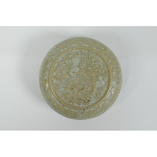 191 - A Chinese celadon crackle glazed porcelain box and cover with raised mythical creature decoration, 9... 