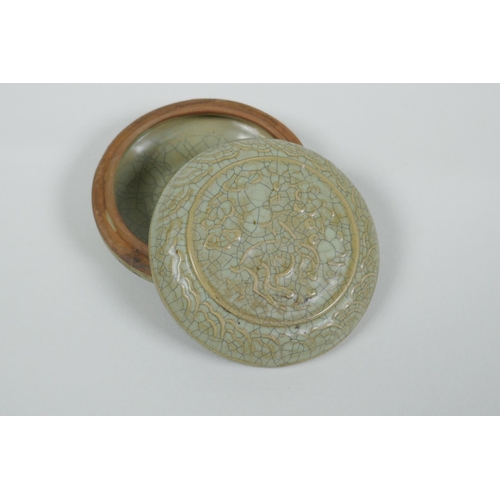 191 - A Chinese celadon crackle glazed porcelain box and cover with raised mythical creature decoration, 9... 