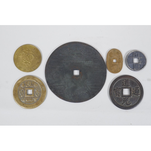 194 - A large Chinese bronze pi-disc, and other smaller bronze pi-discs and tokens, largest 12cm diameter